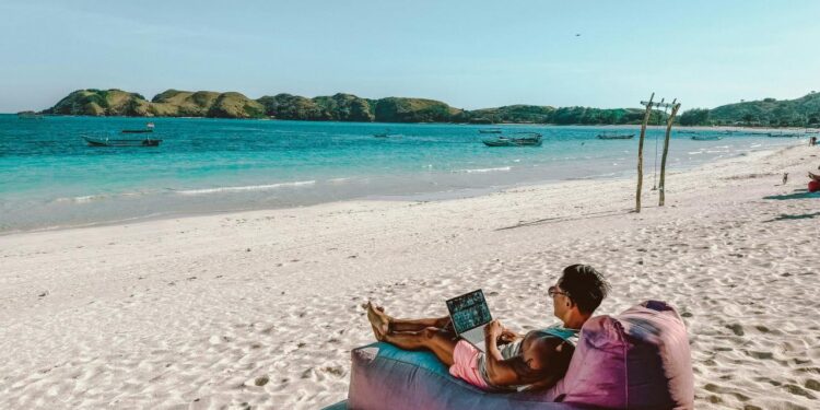 a man sitting on a bean bag on the beach